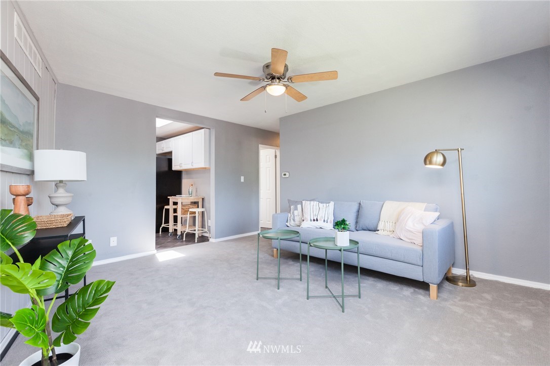 634 Ferndale Place Northeast Renton, WA 98056 - Photo 4 of 25 a living room with furniture and a chandelier