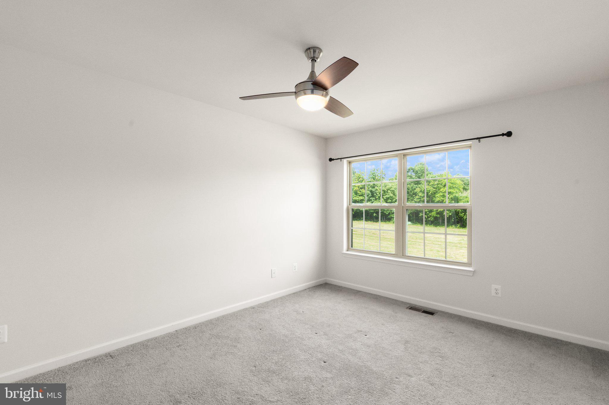 9943 Ravenhurst Road Middle River, MD 21220 - Photo 11 of 23 an empty room with a window and ceiling fan