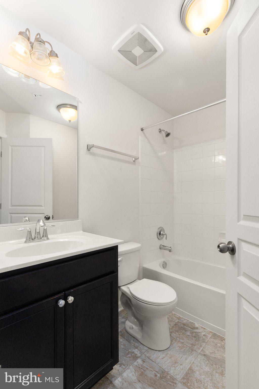 9943 Ravenhurst Road Middle River, MD 21220 - Photo 18 of 23 a bathroom with a toilet a sink and a mirror