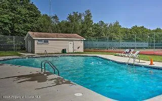 a view of a house with swimming pool and a yard