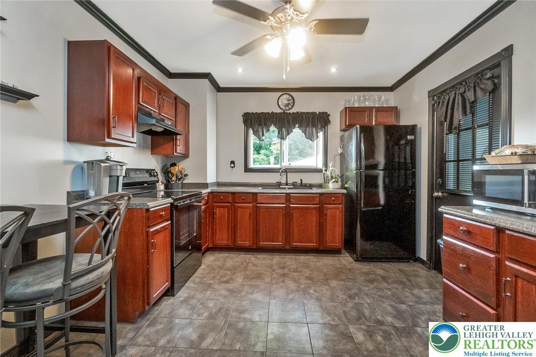 365 Rock Street Easton, PA 18042 - Photo 13 of 50 Well-equipped kitchen features ample cabinetry, durable countertops, and sleek black appliances for effortless meal preparation.