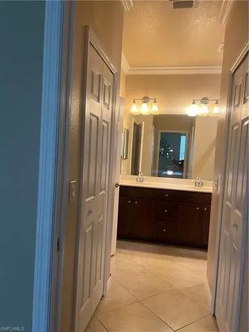a spacious bathroom with a mirror and a sink