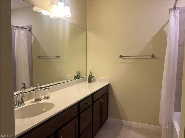 a bathroom with a double vanity sink and mirror