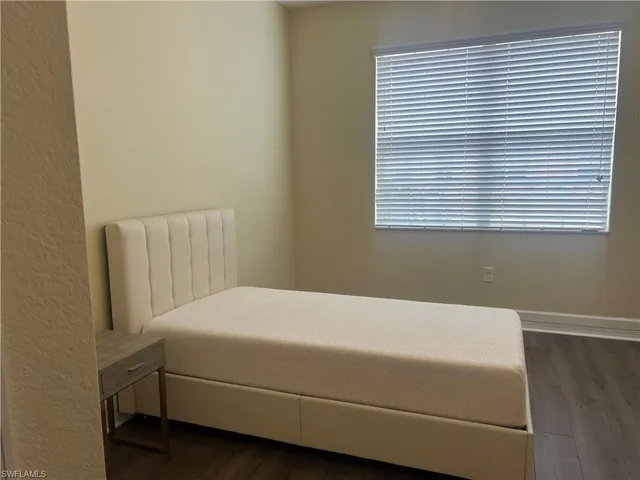 a room with a bed and a window