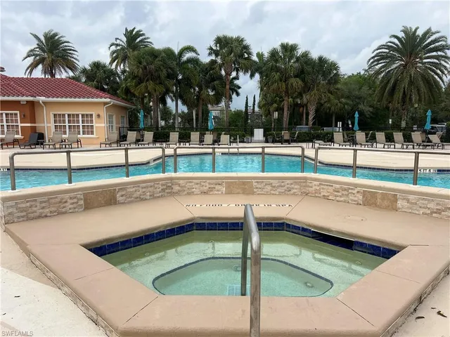 a view of swimming pool with outdoor seating and lake