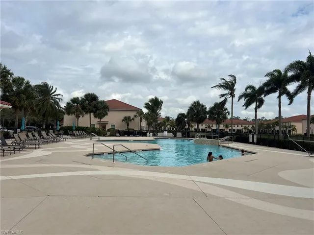 a view of a dining room and livingroom with furniture wooden floor and a rug