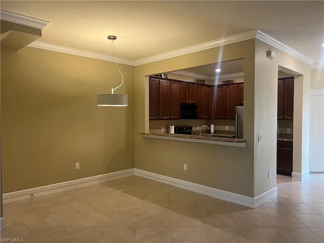 a view of kitchen and refrigerator