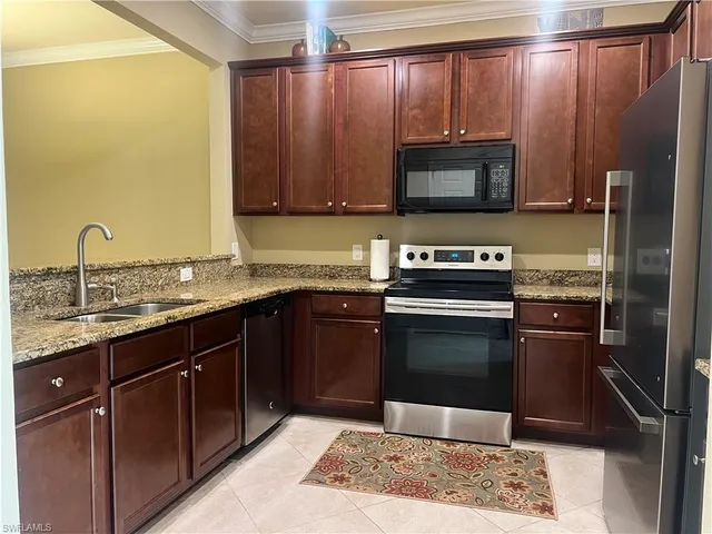 a kitchen with a sink stove and microwave