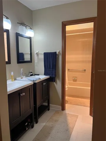a bathroom with a double vanity sink and mirror
