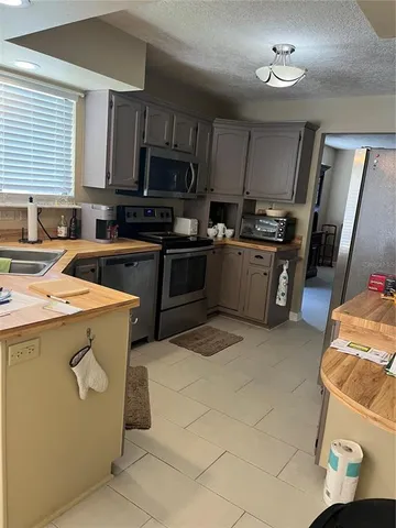 a kitchen with a sink appliances and cabinets