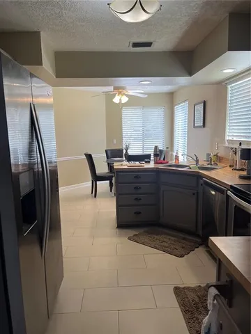 a kitchen with a sink a stove and cabinets