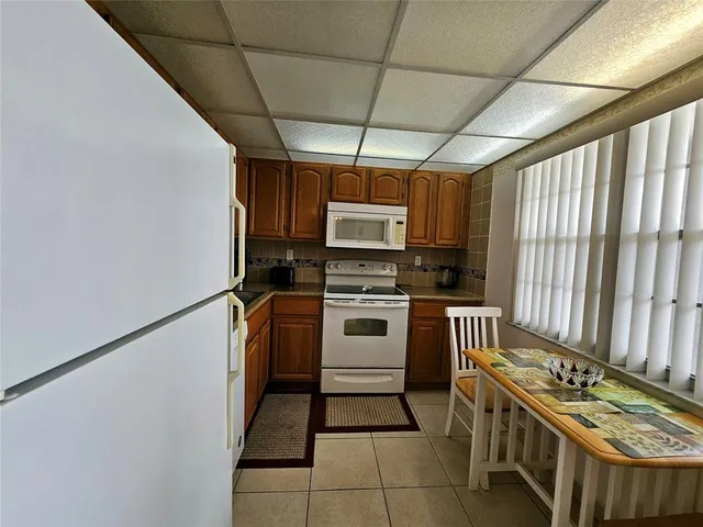 a kitchen with stainless steel appliances a stove a sink and a refrigerator