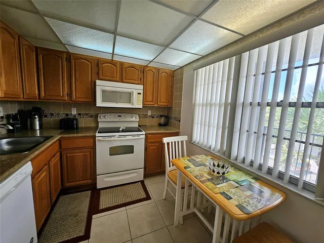 a kitchen with a stove a sink and a microwave