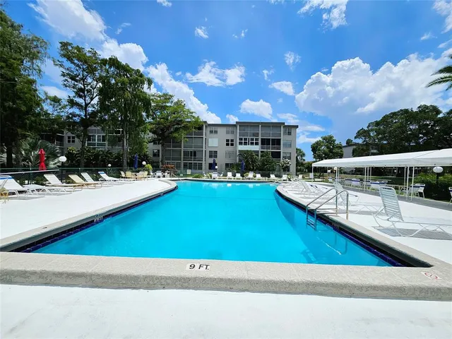 a view of a swimming pool with outdoor seating