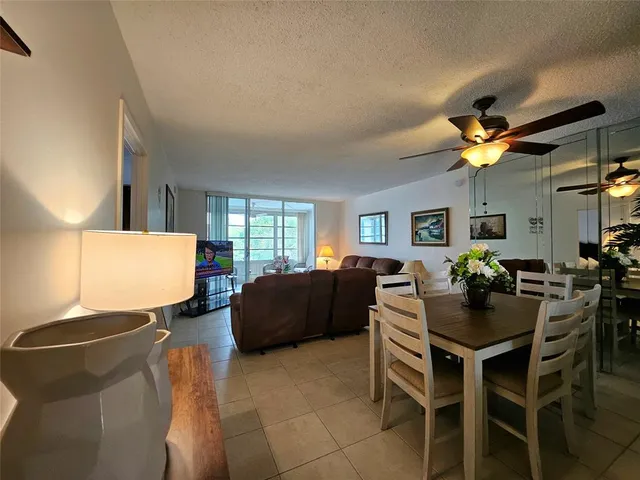 a living room with furniture a chandelier and a window