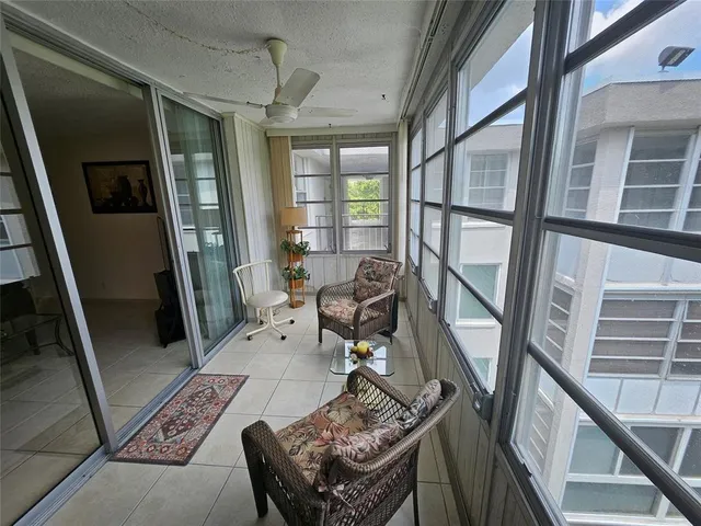 a living room with furniture and a floor to ceiling window