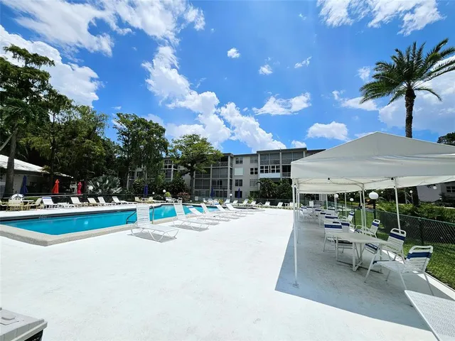 a view of a swimming pool with a table and chairs