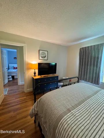 a bedroom with a bed and a television