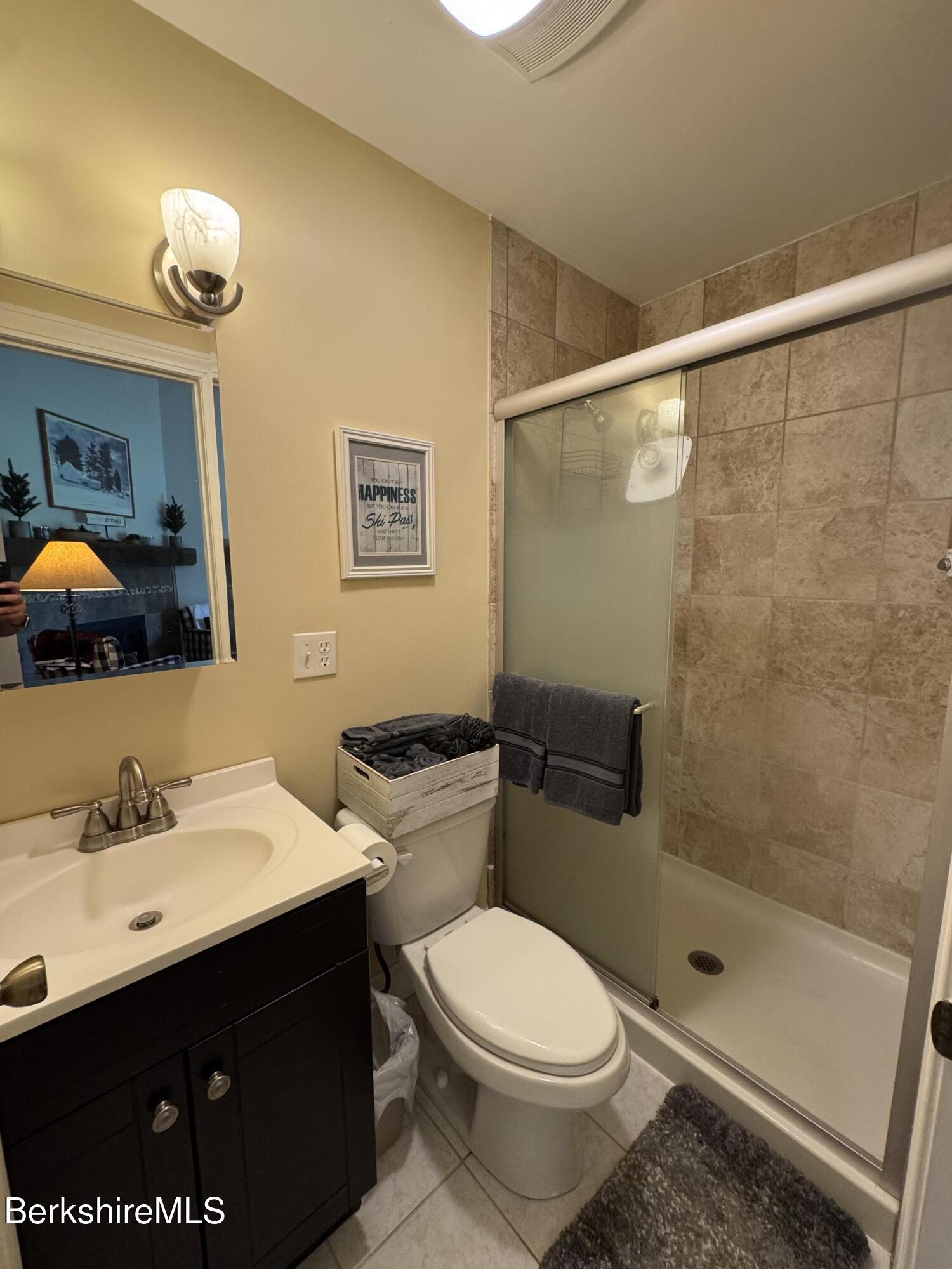 37 Corey Road, Unit 73 Hancock, MA 01237 - Photo 13 of 24 a bathroom with a sink mirror vanity and toilet
