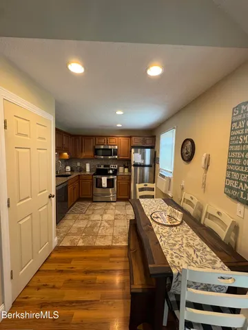 a large kitchen with a table and chairs