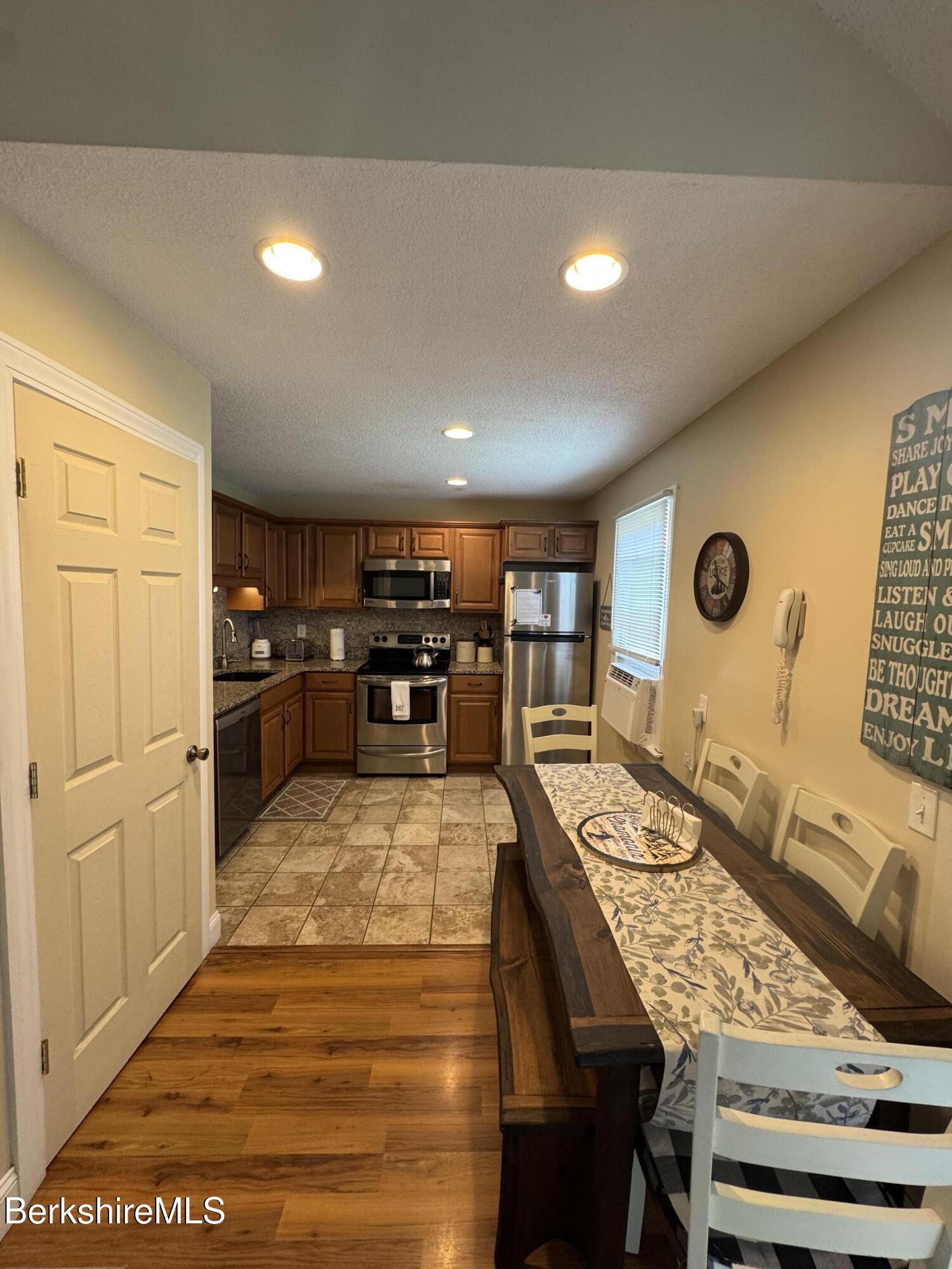 37 Corey Road, Unit 73 Hancock, MA 01237 - Photo 16 of 24 a large kitchen with a table and chairs