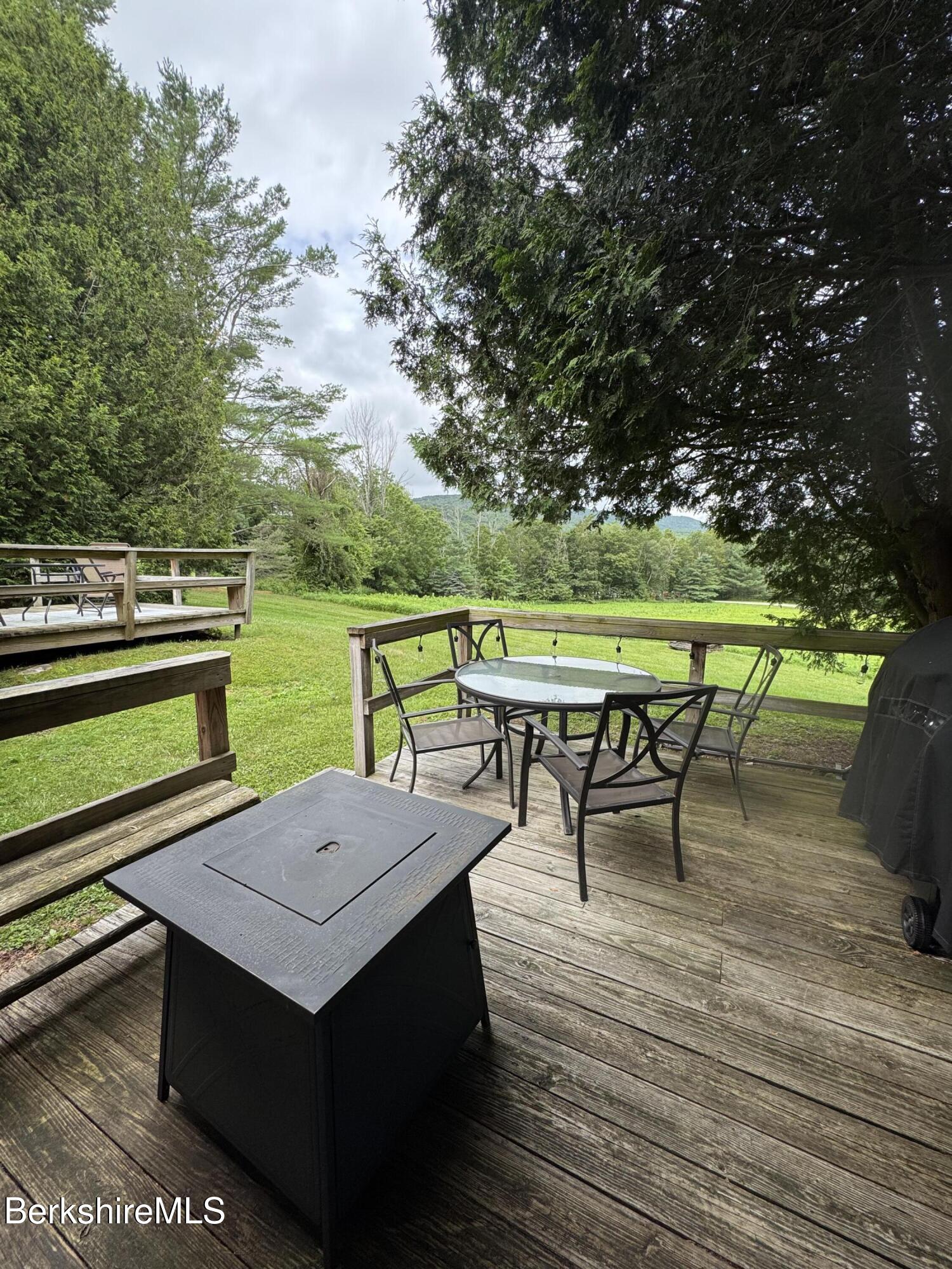 37 Corey Road, Unit 73 Hancock, MA 01237 - Photo 22 of 24 an outdoor sitting area with furniture and wooden floor