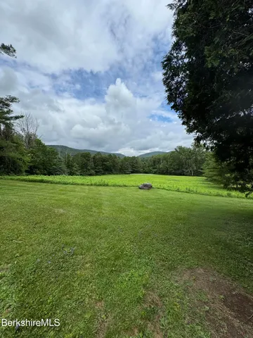a view of a green field with clear sky