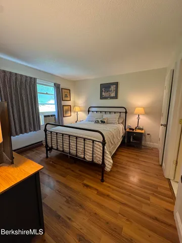 a spacious bedroom with two beds and a desk