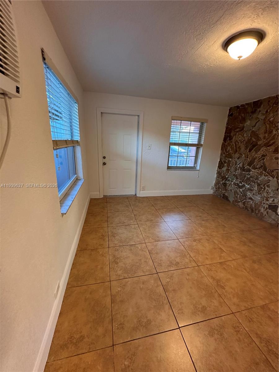6131 Southwest 39th Street, Unit EAST Miramar, FL 33023 - Photo 12 of 15 a view of an empty room and window