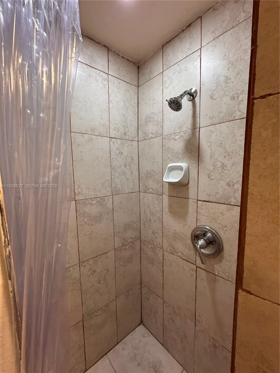 6131 Southwest 39th Street, Unit EAST Miramar, FL 33023 - Photo 9 of 15 a bathroom with a shower