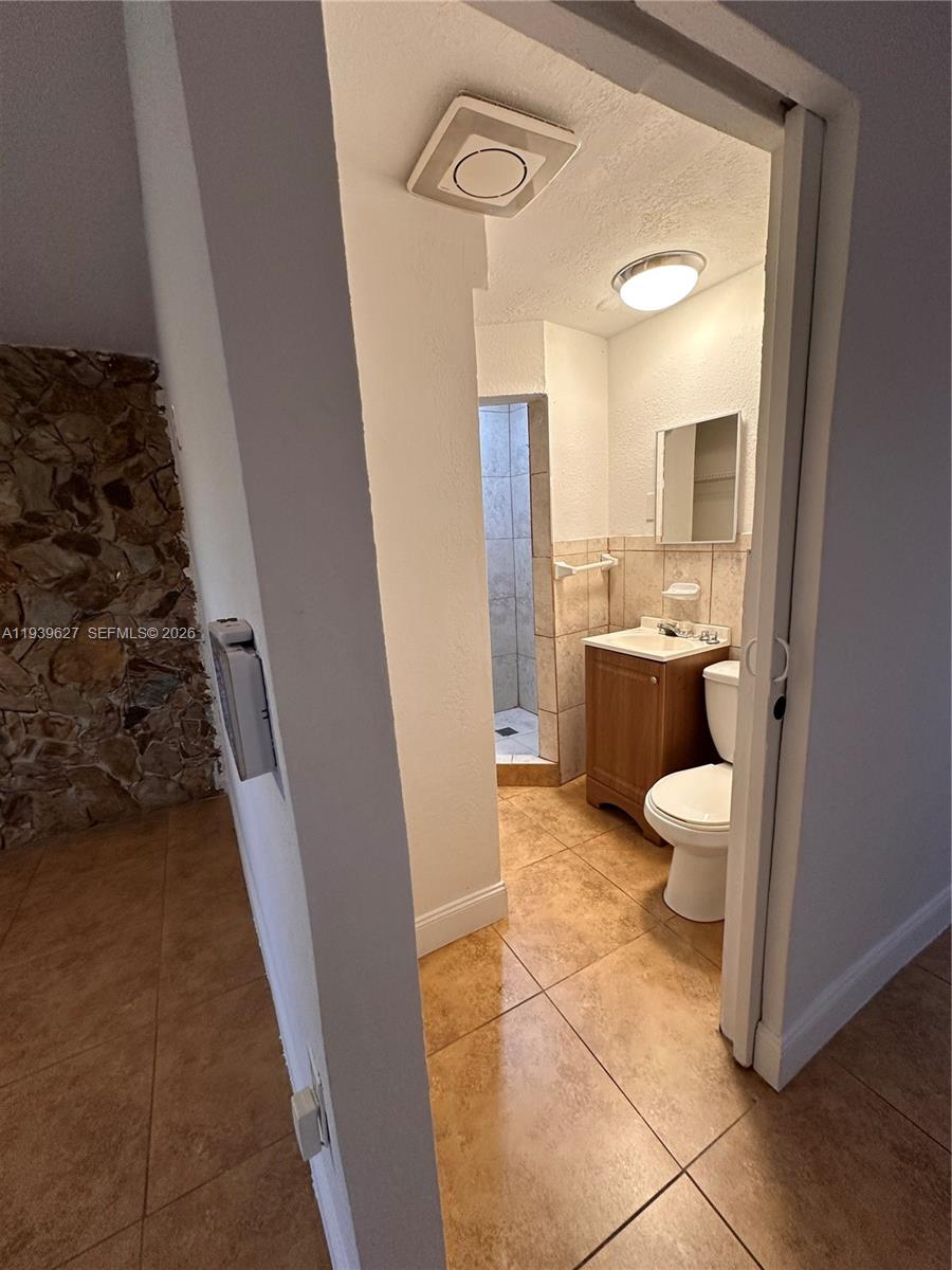 6131 Southwest 39th Street, Unit EAST Miramar, FL 33023 - Photo 10 of 15 a bathroom with a sink a toilet and a shower