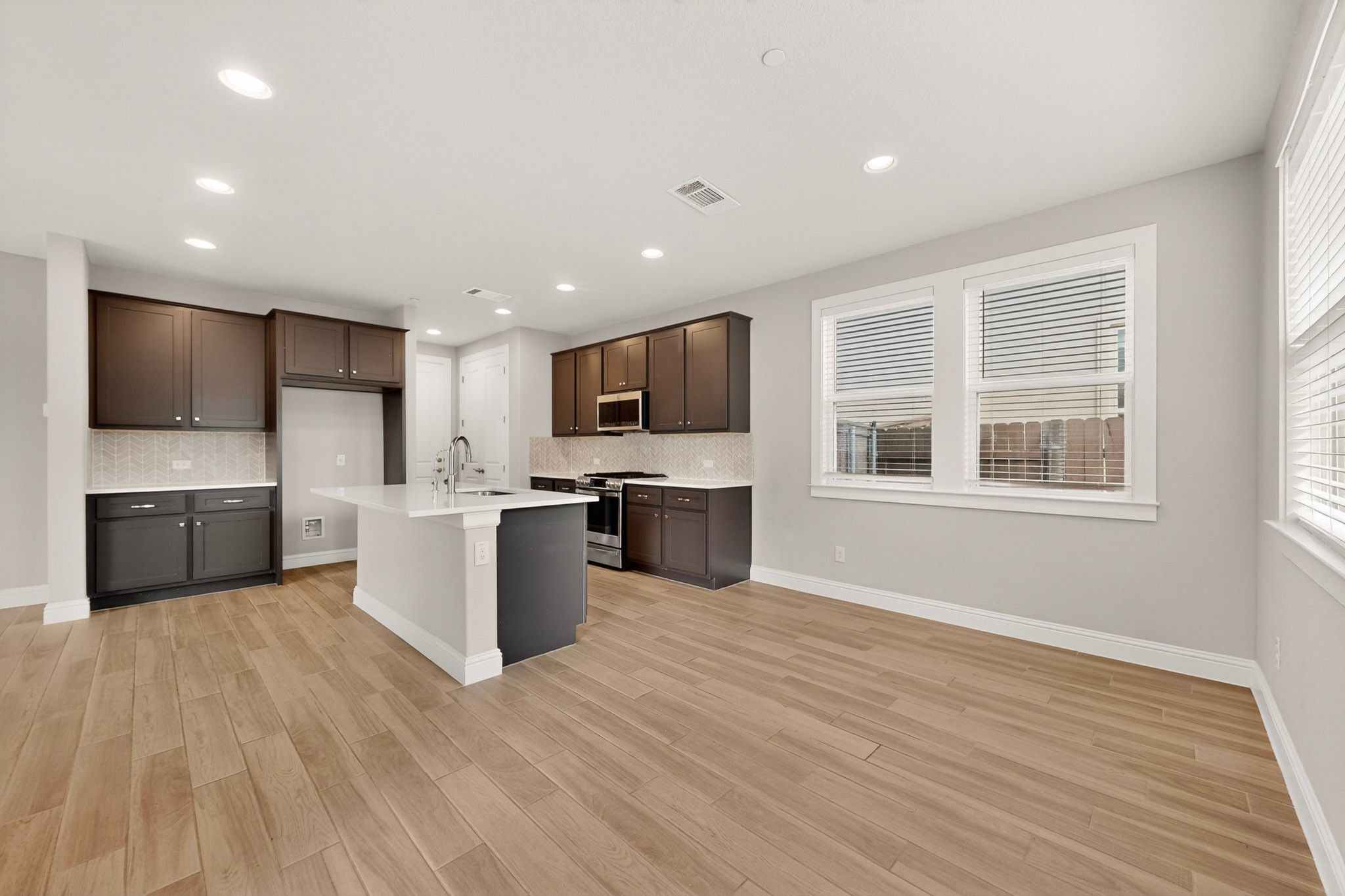 2605 Sam Bass Road, Unit 9 Round Rock, TX 78681 - Photo 14 of 38 A well-lit kitchen with a central island and rich cabinetry offers effortless living.