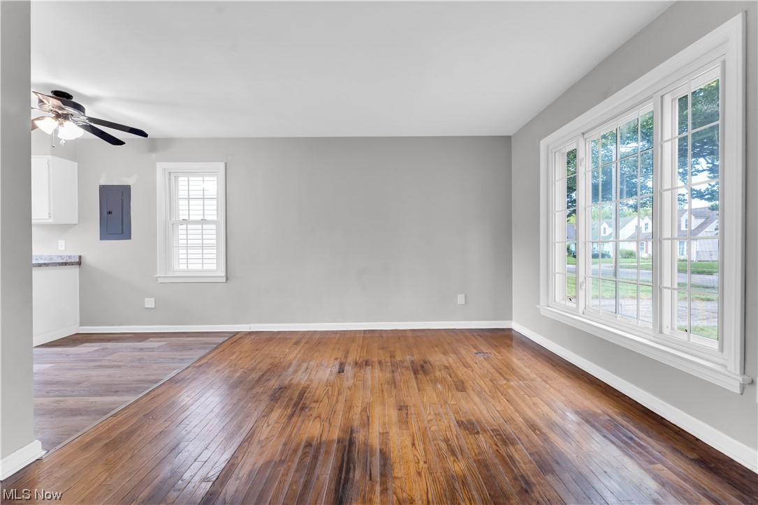 18805 Homeway Road Cleveland, OH 44135 - Photo 3 of 23 Unfurnished room with ceiling fan, dark hardwood floors, and a healthy amount of sunlight