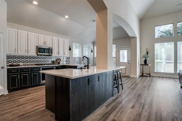 a kitchen with a sink and wooden cabinets
