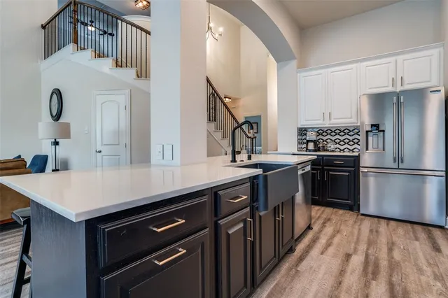 a kitchen with kitchen island a sink stove and refrigerator
