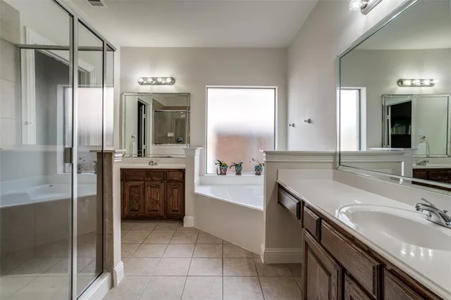 a bathroom with a granite countertop sink double vanity and a mirror