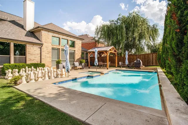 a view of a house with swimming pool and sitting area
