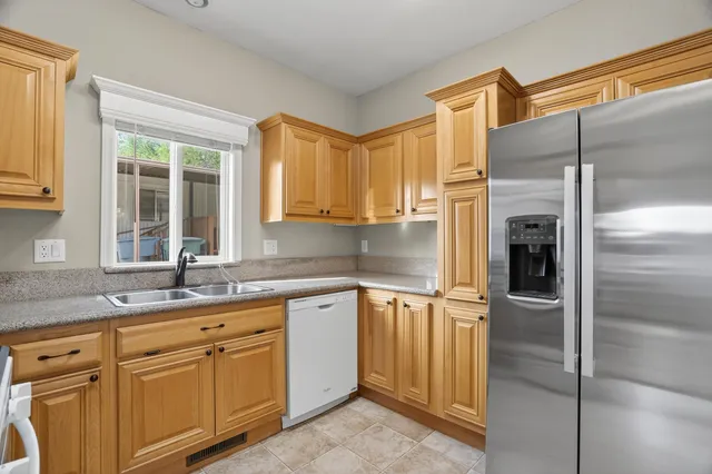 a kitchen with a sink and refrigerator