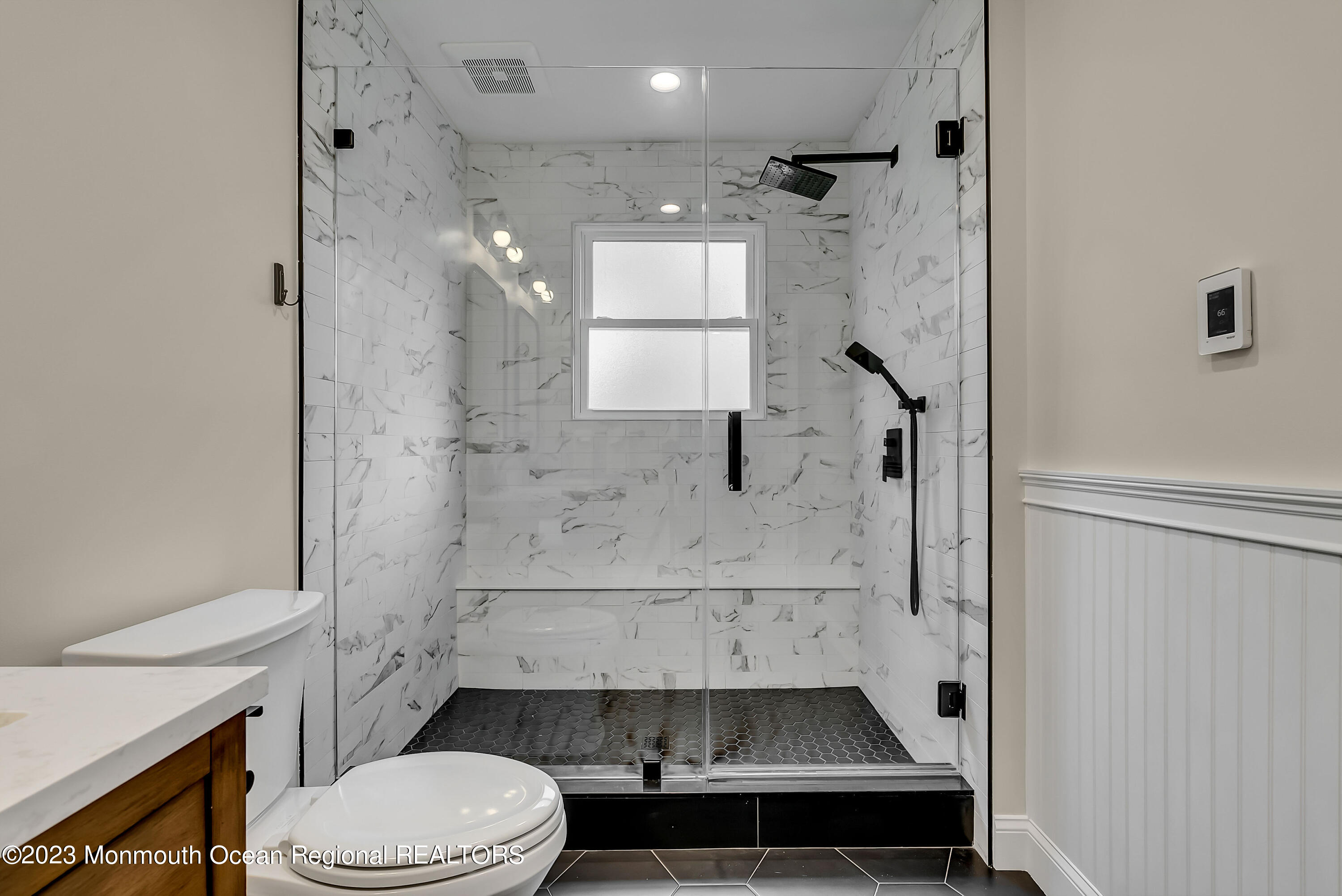 515 Monmouth Road West Allenhurst, NJ 07711 - Photo 13 of 45 a bathroom with a sink a toilet and shower