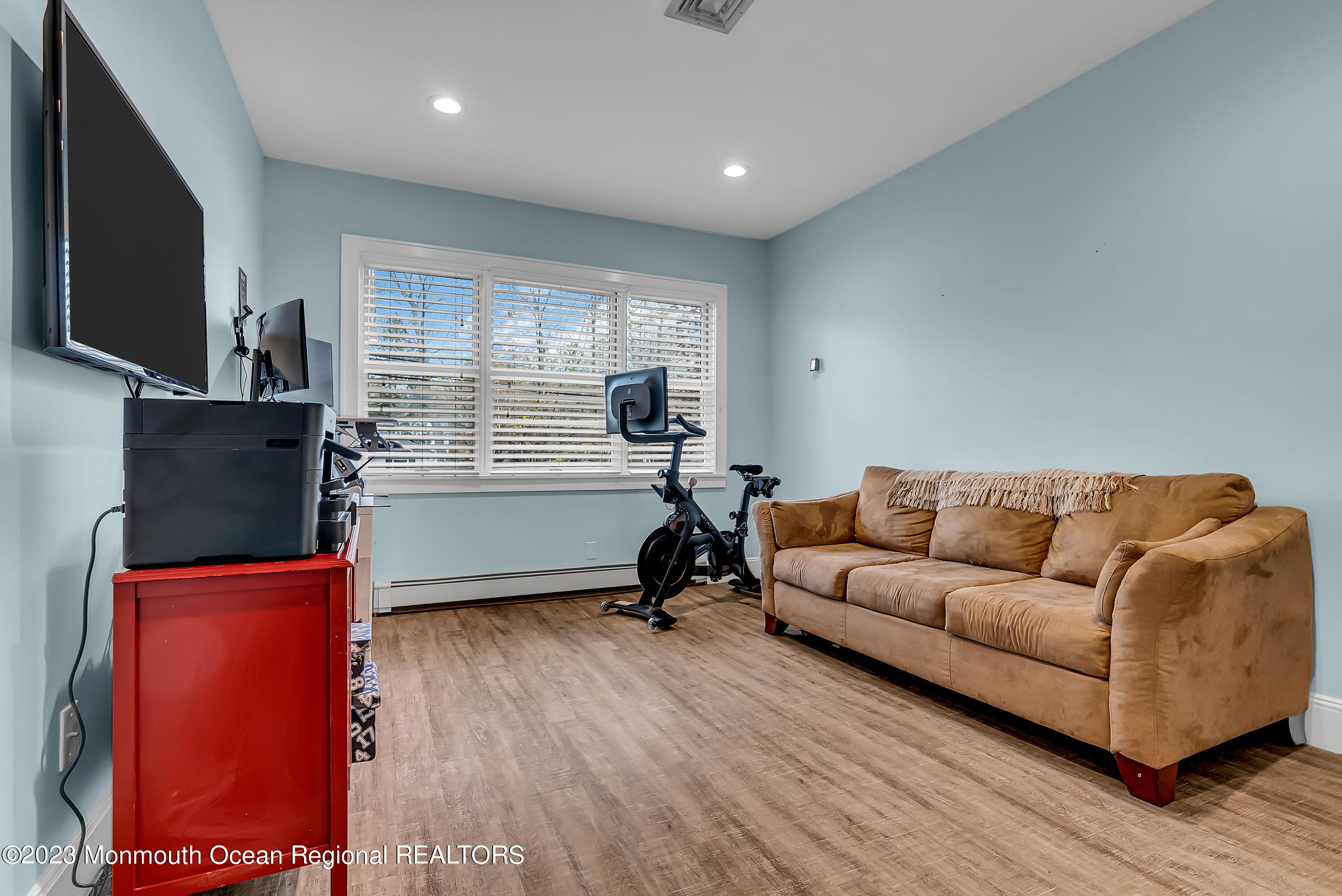 515 Monmouth Road West Allenhurst, NJ 07711 - Photo 16 of 45 a living room with furniture gym equipment and a flat screen tv