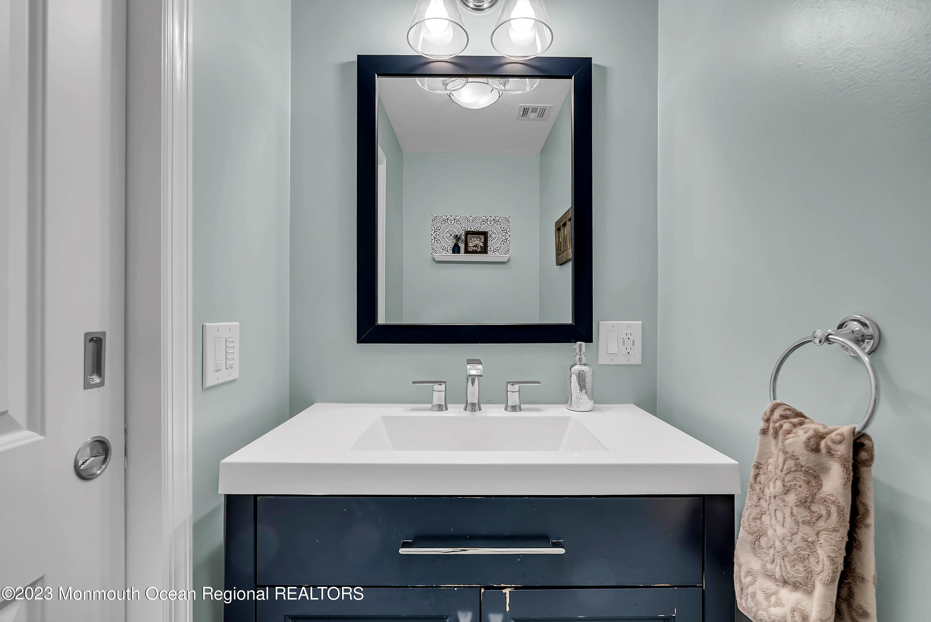 515 Monmouth Road West Allenhurst, NJ 07711 - Photo 19 of 45 a bathroom with a sink and a mirror