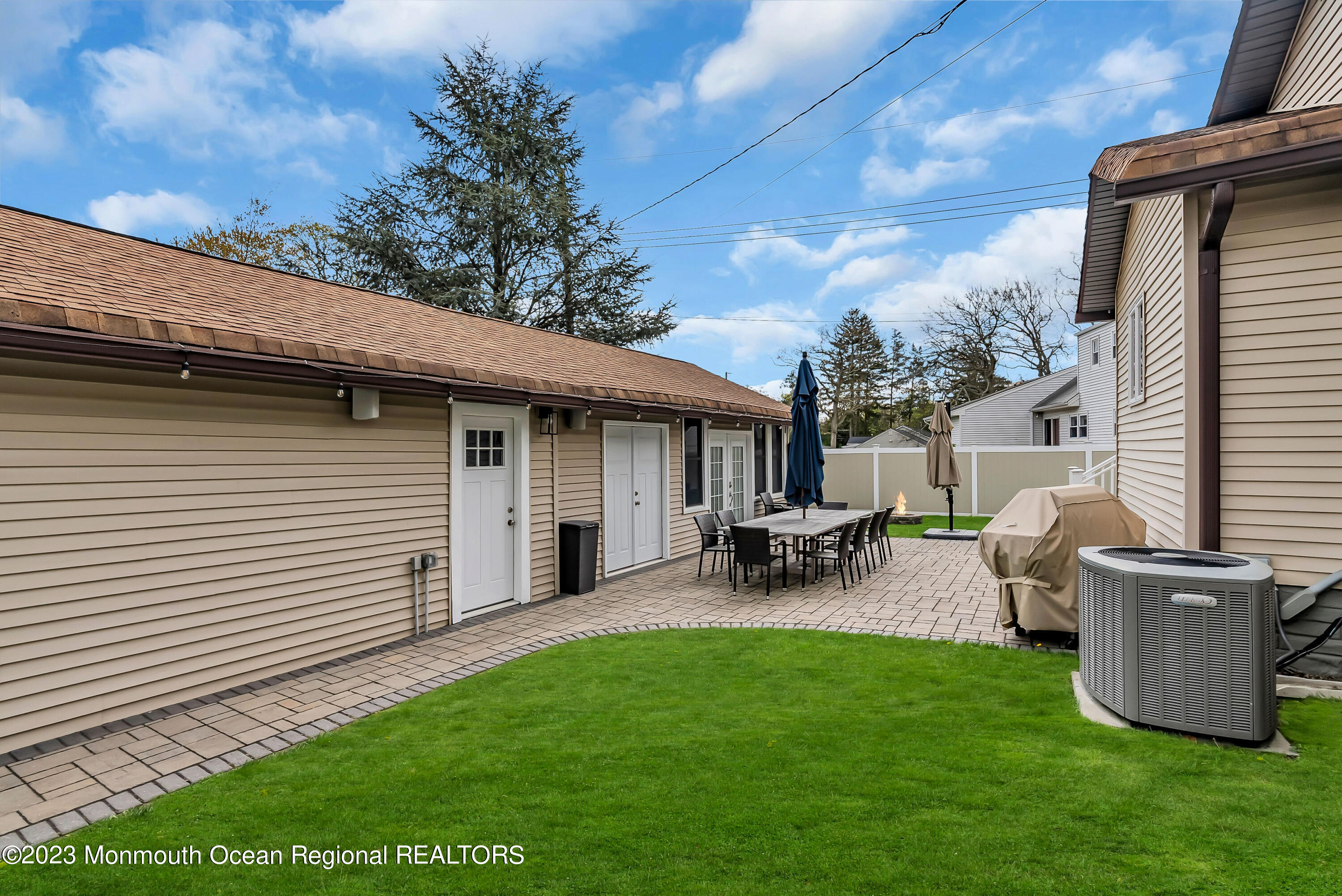 515 Monmouth Road West Allenhurst, NJ 07711 - Photo 23 of 45 a view of a backyard with table and chairs and a barbeque