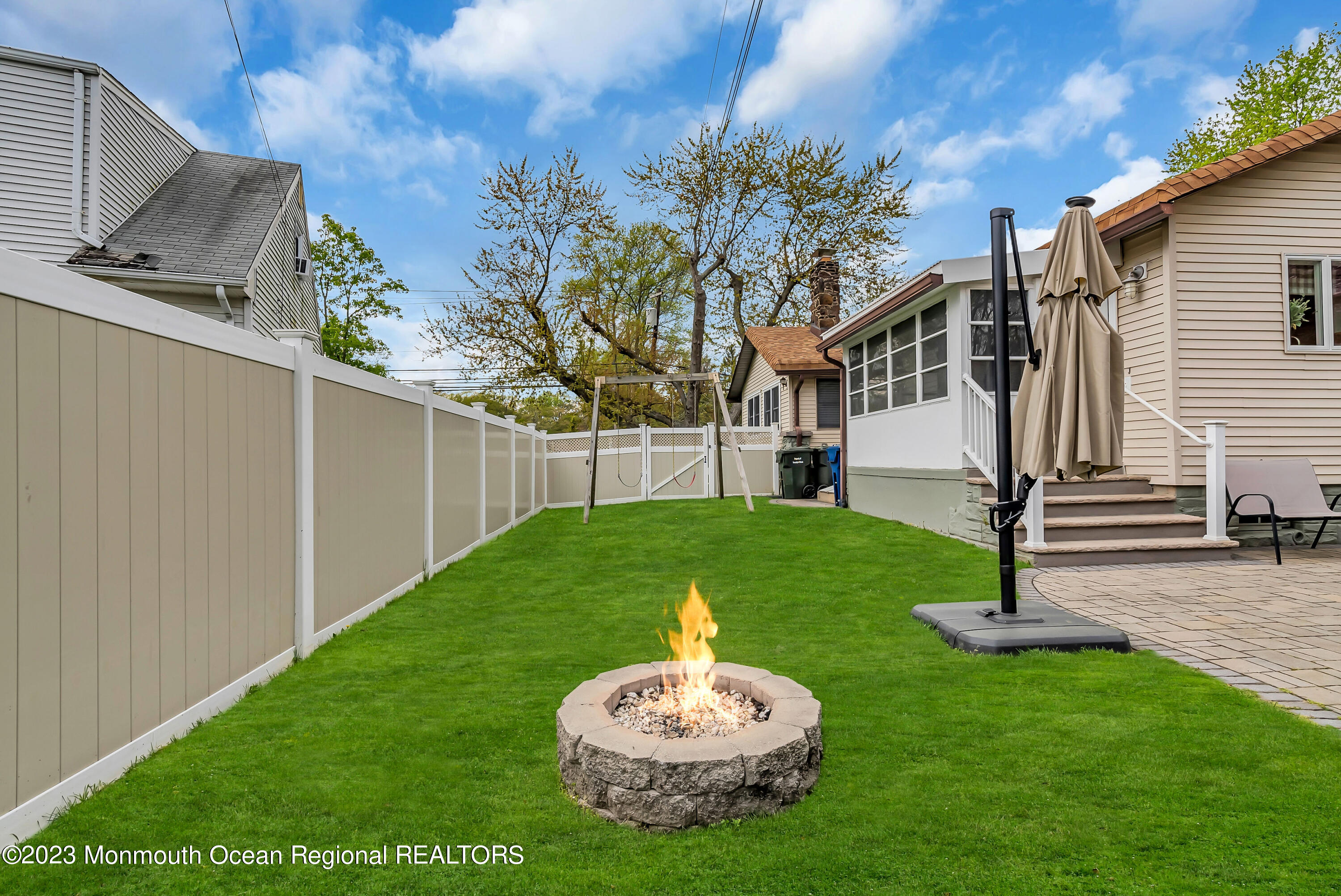 515 Monmouth Road West Allenhurst, NJ 07711 - Photo 24 of 45 a backyard of a house with a table and chairs