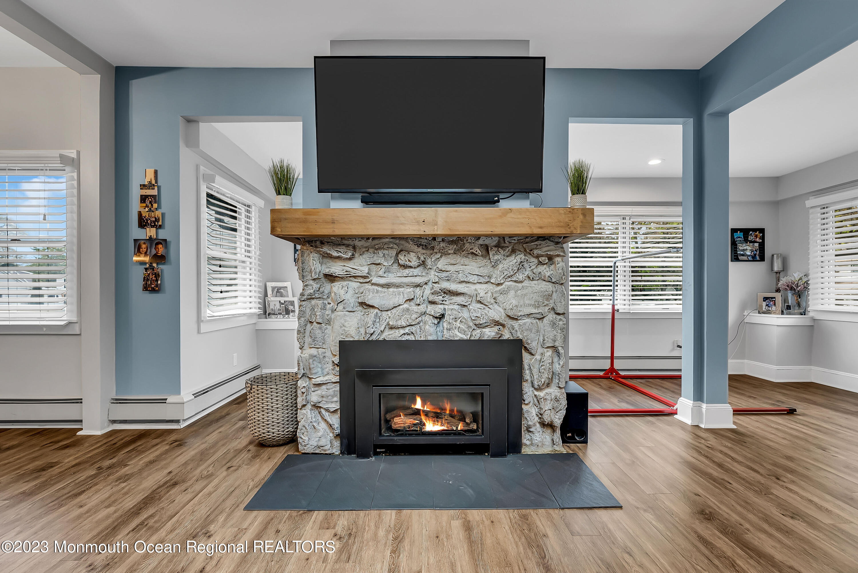 515 Monmouth Road West Allenhurst, NJ 07711 - Photo 38 of 45 a living room with a fireplace a flat screen tv and a fireplace
