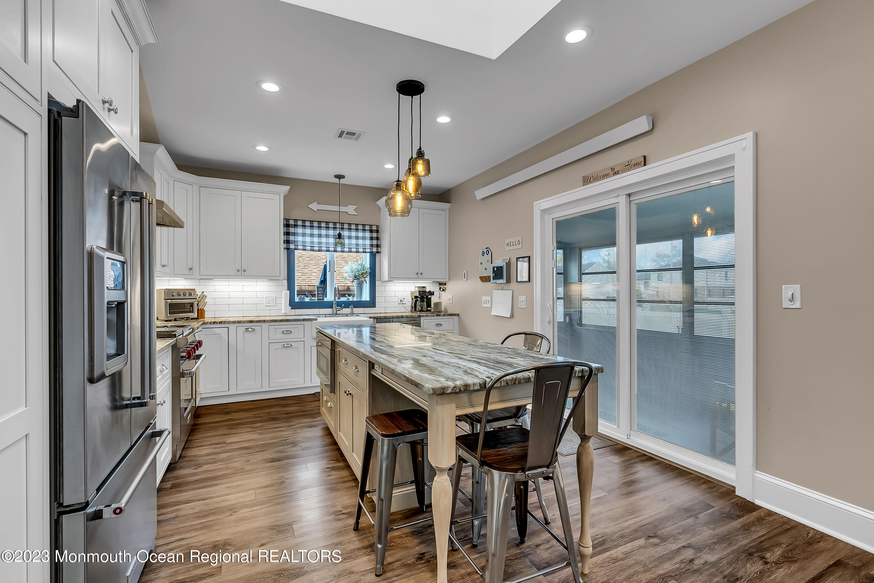 515 Monmouth Road West Allenhurst, NJ 07711 - Photo 41 of 45 a kitchen with stainless steel appliances granite countertop a table chairs sink and cabinets