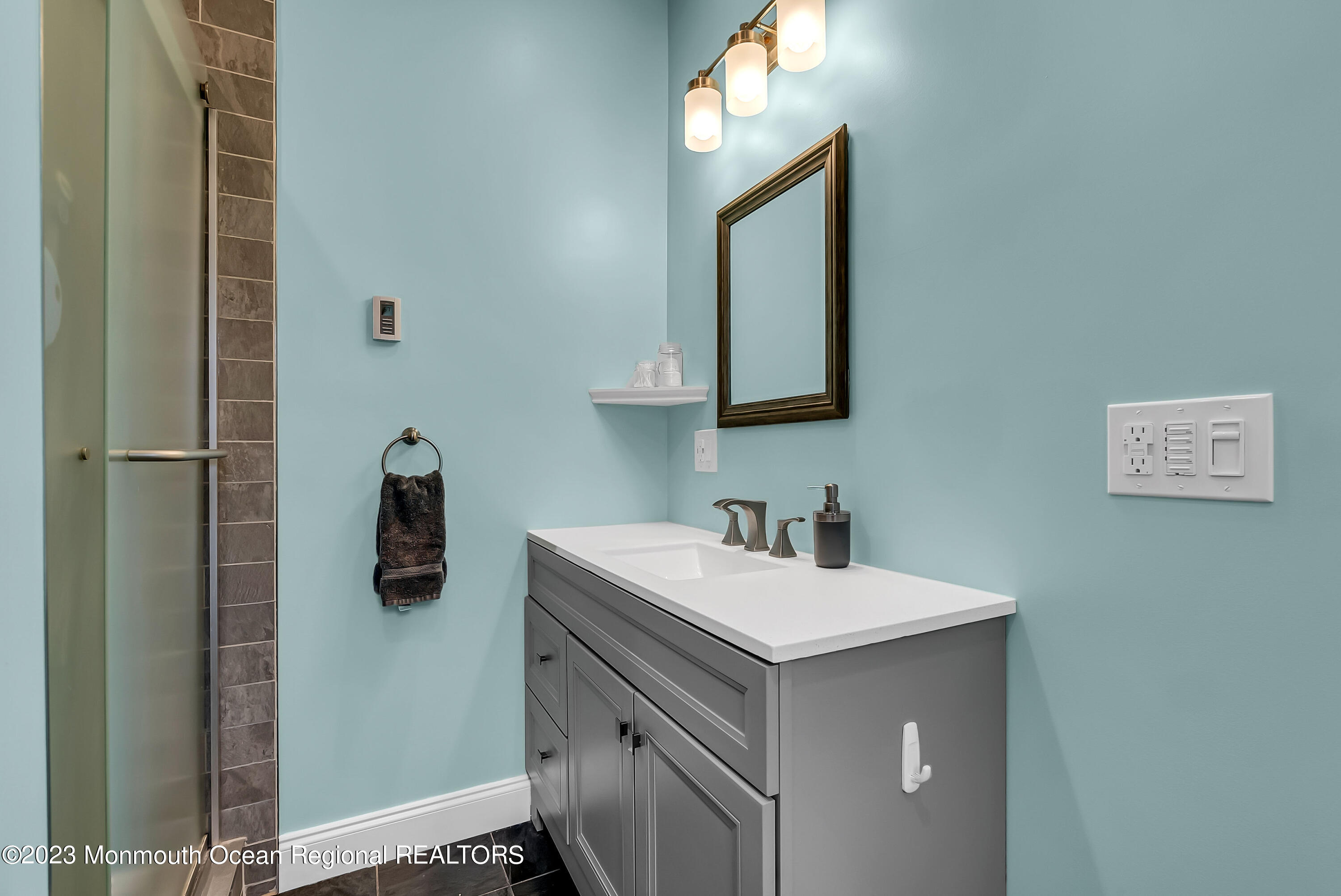 515 Monmouth Road West Allenhurst, NJ 07711 - Photo 43 of 45 a bathroom with a sink vanity and a mirror
