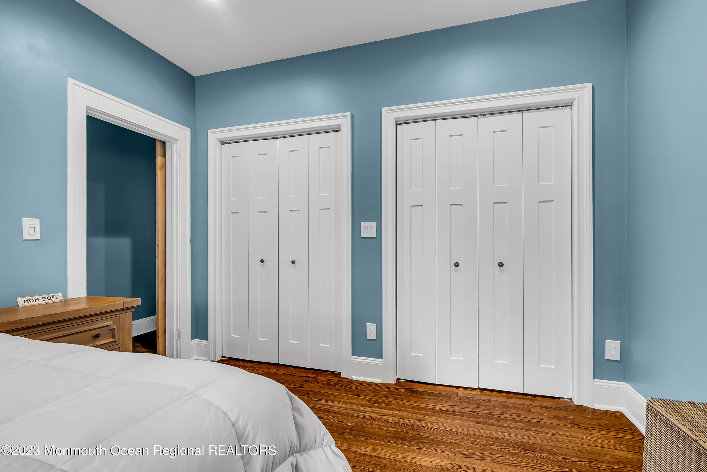 515 Monmouth Road West Allenhurst, NJ 07711 - Photo 8 of 45 a bedroom with a bed and wooden floor