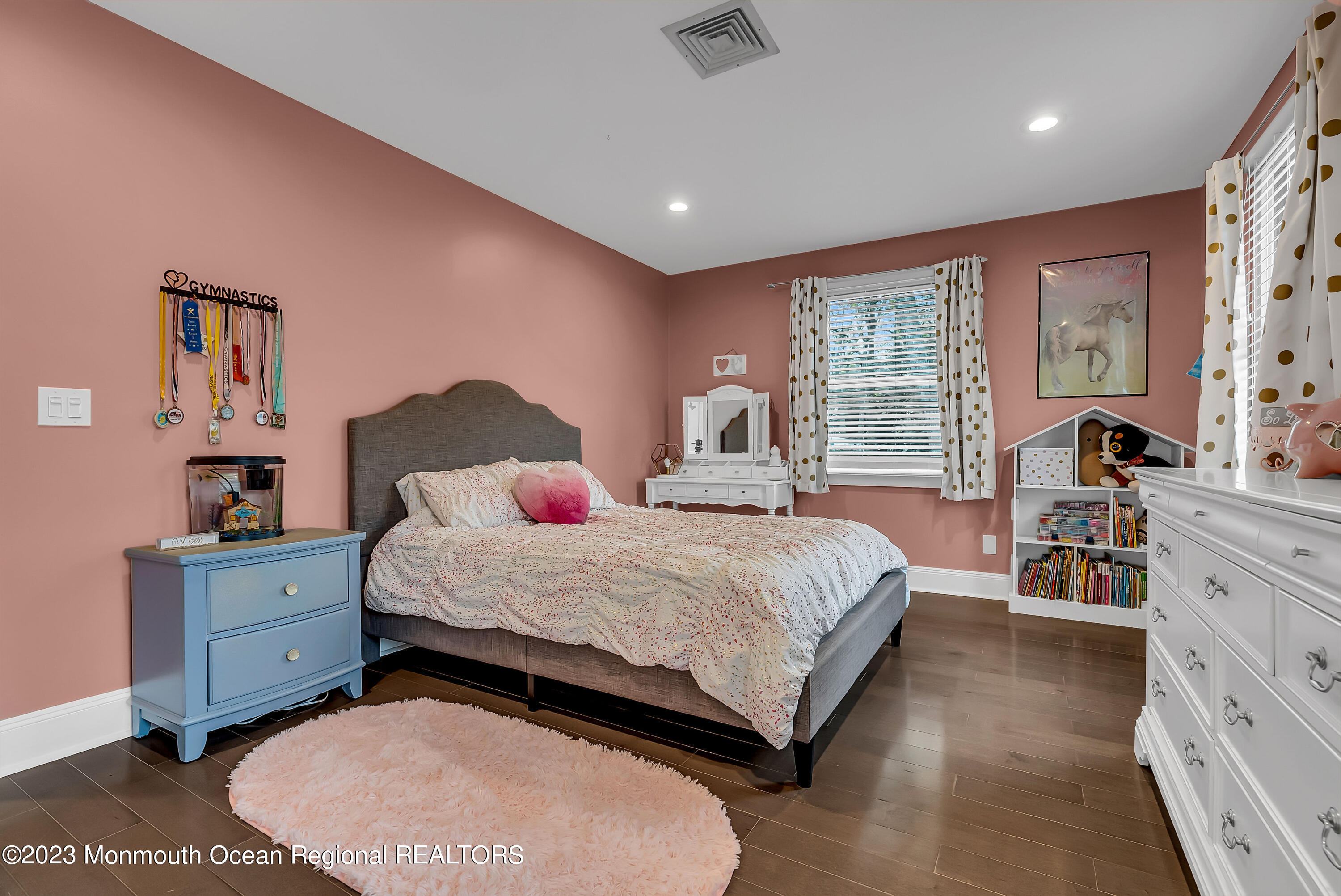 515 Monmouth Road West Allenhurst, NJ 07711 - Photo 10 of 45 a spacious bedroom with a bed and wooden floor