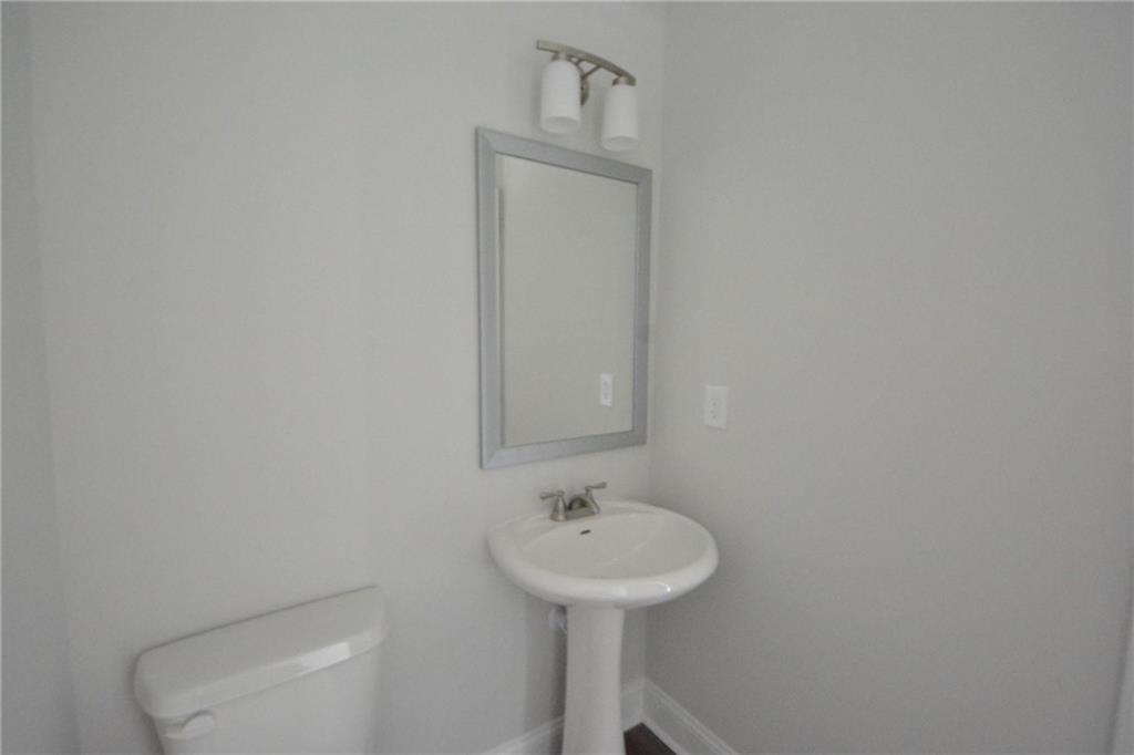 3871 Brookburn Park Gainesville, GA 30506 - Photo 16 of 28 a bathroom with a sink a toilet and mirror