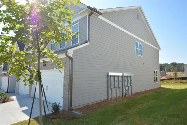 a backyard of a house with table and chairs
